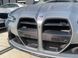 Carbon fiber air intake scoops for BMW M3 G80 & M4 G82 installation on car front side view behind drill front mount